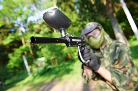 Paintball Player with paintball gun and other equipment