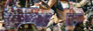 Paintball, team work or people running in shooting game with speed or fast action on a fun battlefield. Mission focus, blurry caravan or men with guns for survival in competition in nature or forest.