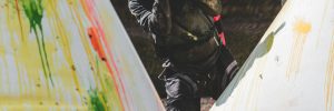 Paintball Player hiding behind barrier
