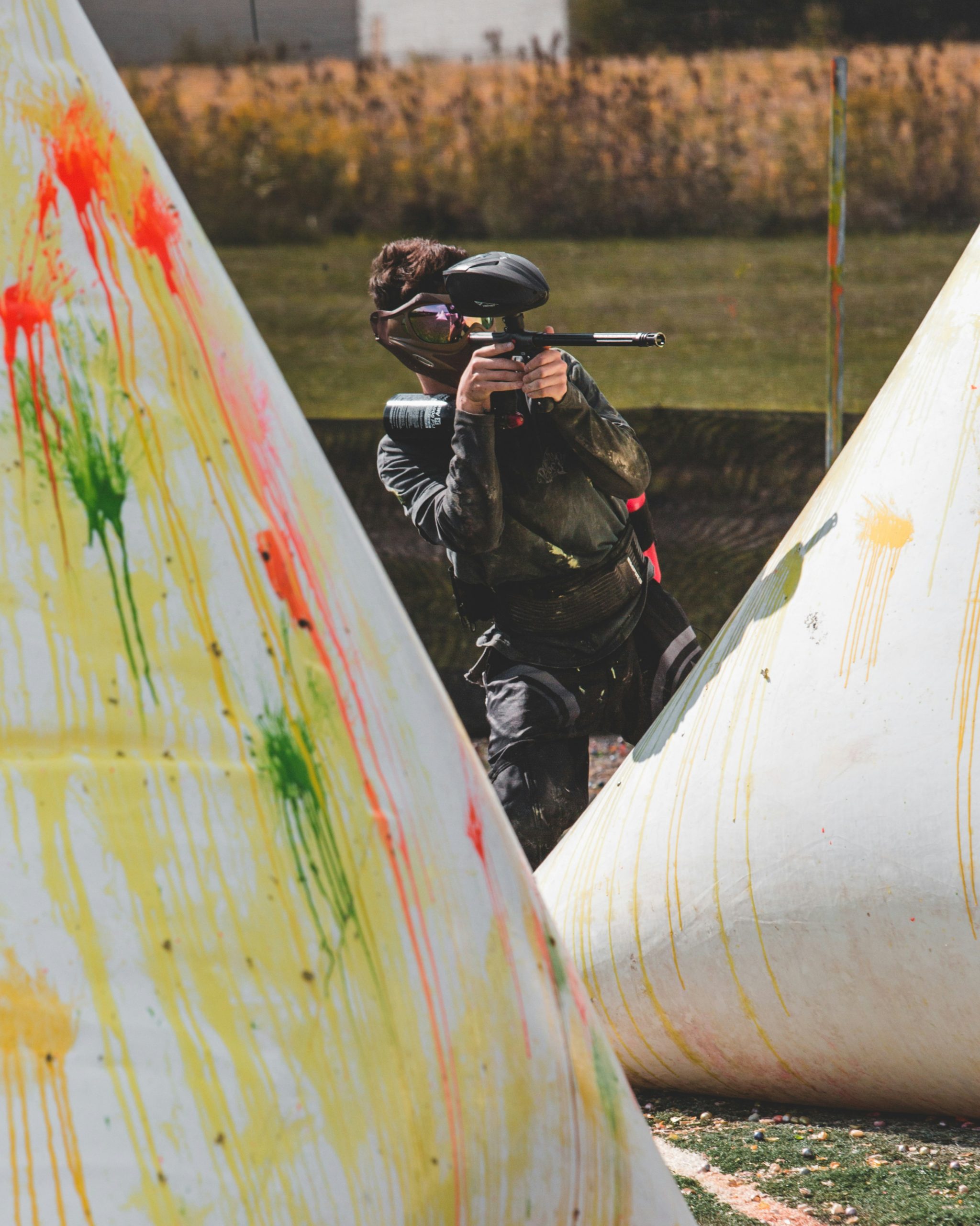 Paintball Player hiding behind barrier